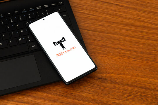 Punta Arenas, Chile &ndash; February 04, 2026: A smartphone displaying the Tmall cat head logo and wordmark on a white screen, resting on a black laptop keyboard
