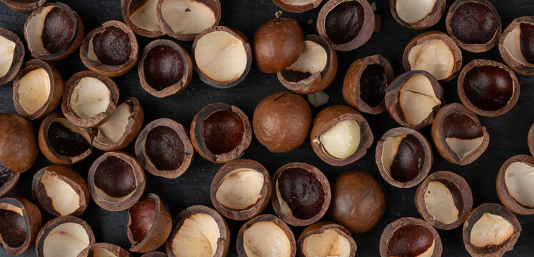 Macadamia nuts pattern. Natural raw peeled macadamia seeds and shells