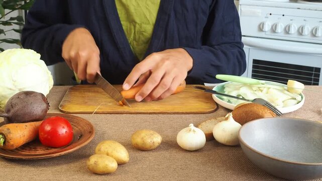 A man is preparing borscht with cabbage