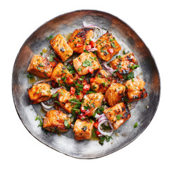 Pan-seared salmon chunks with fresh herbs, diced peppers, and red onion on metal plate