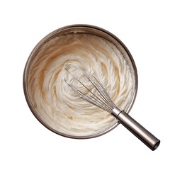 Overhead shot of a stainless steel whisk in a bowl of freshly whipped white cream or frosting