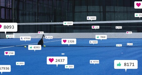 Leaning black tennis racket with yellow balls resting against net on blue court, with social badges