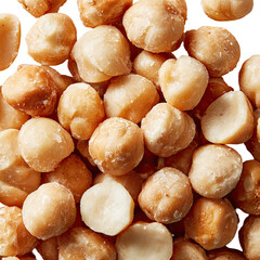 Close-up of numerous golden-brown, shelled macadamia nuts piled together, glistening softly