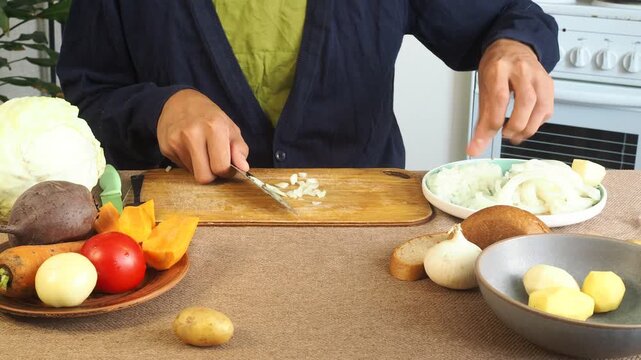 A man is preparing borscht with cabbage