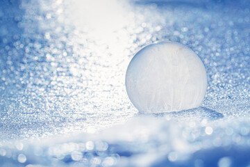 Frozen Soap Bubble Rests on Ice at Sunrise on a Sub Zero Day