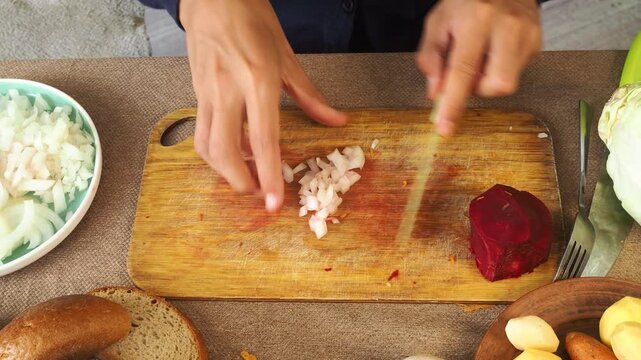 A man is preparing borscht with cabbage