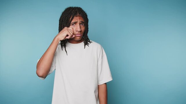 Young person shows different emotions in a series of expressions against a blue background