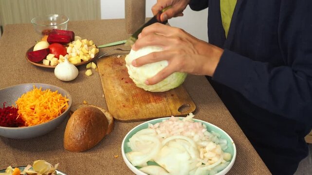 A man is preparing borscht with cabbage