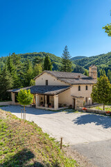 Rural Umbrian church building surrounded by green hills