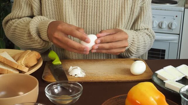a man making egg sandwiches for breakfast