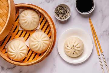 Steamed buns in bamboo steamer on a kitchen counter