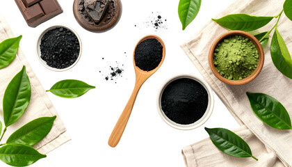 Overhead shot of dark powders, matcha, leaves, wooden spoon, and fabric on a black surface