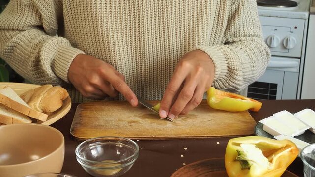 a man making egg sandwiches for breakfast