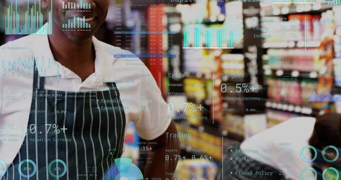 Grocery clerk stepping forward and making OK gesture while coworker restocking showing sales charts