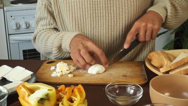 a man making egg sandwiches for breakfast
