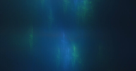 Vibrant abstract background showcasing blue and green light patterns blending together on a dark background.