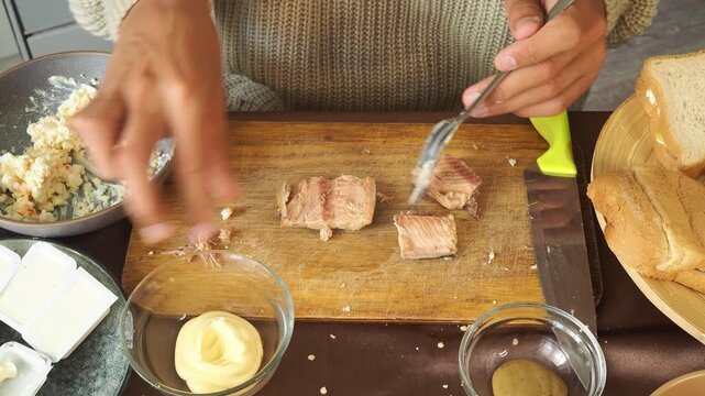 a man making egg sandwiches for breakfast