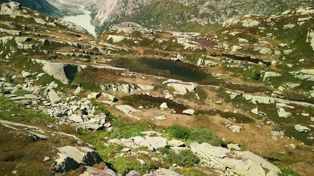 Majestic mountain view of Swiss Alps with rocky snowy mountain peaks and lake