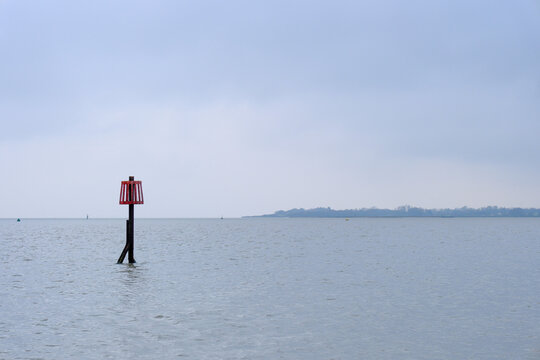 A Red Port Marker Buoy in the Colne River estuary near Brightlingsea, UK