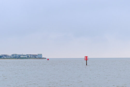 A Red Port Marker Buoy in the Colne River estuary near Brightlingsea, UK
