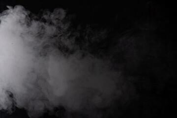 Thick white smoke across black background, billowing plume with soft diffusion, moody studio lighting, high contrast texture, ethereal