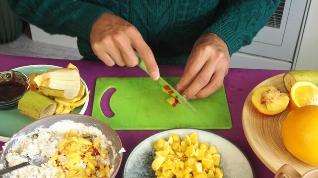a man preparing a fruit dessert