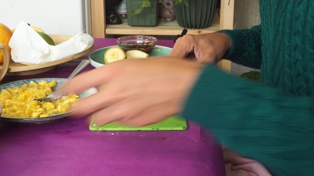 a man preparing a fruit dessert