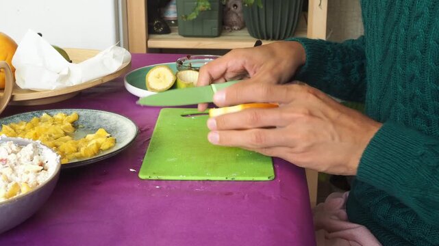 a man preparing a fruit dessert