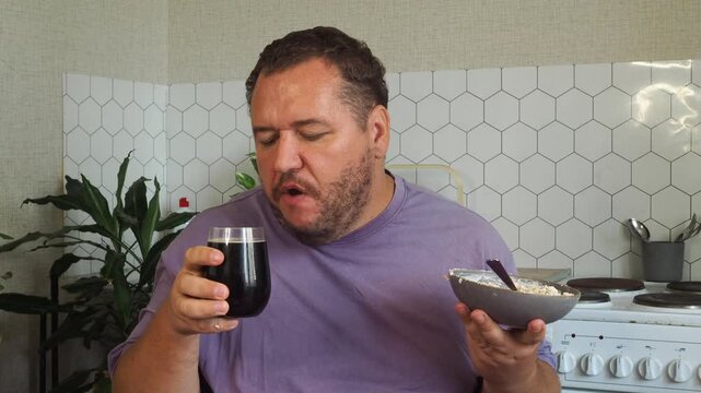 a grown man is having lunch in the kitchen