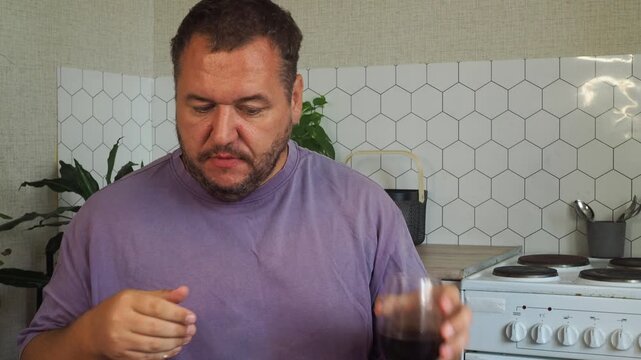 a grown man is having lunch in the kitchen