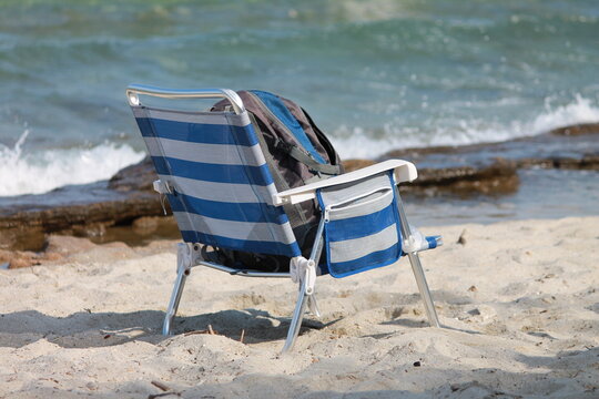 Backpack on a beach by the sea representing summer travel and adventure.
