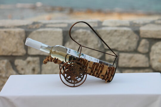 Wintage decorative cannon model against a traditional stone wall in afitos.