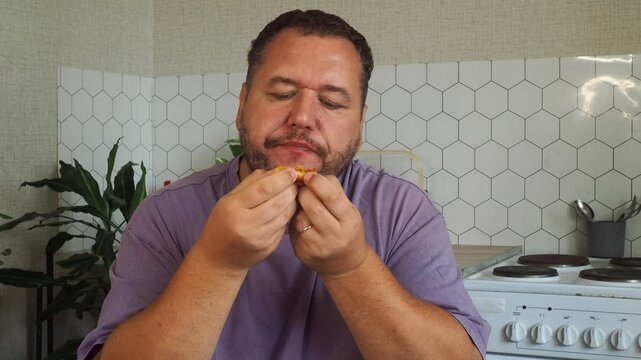 a grown man is having lunch in the kitchen