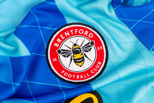 Brentford FC embroidered badge on blue football jersey fabric close up