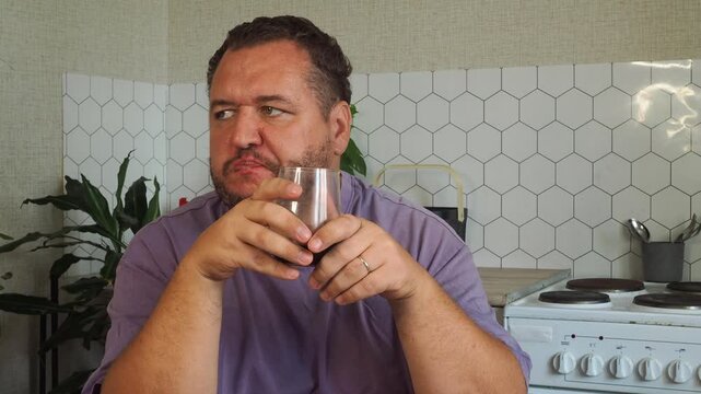 a grown man is having lunch in the kitchen