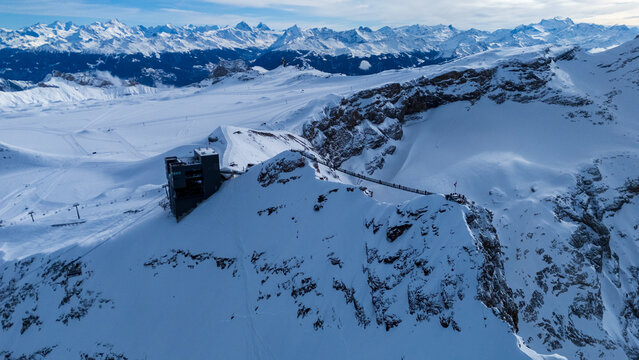 Winter photo of Glacier 3000 in Switzerland, showcasing snow-covered peaks, icy glaciers, and dramatic alpine scenery under a clear mountain sky