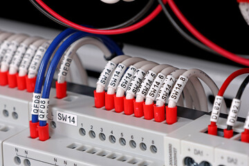 Marking electrical wiring wires with thermally printed nylon tape. 