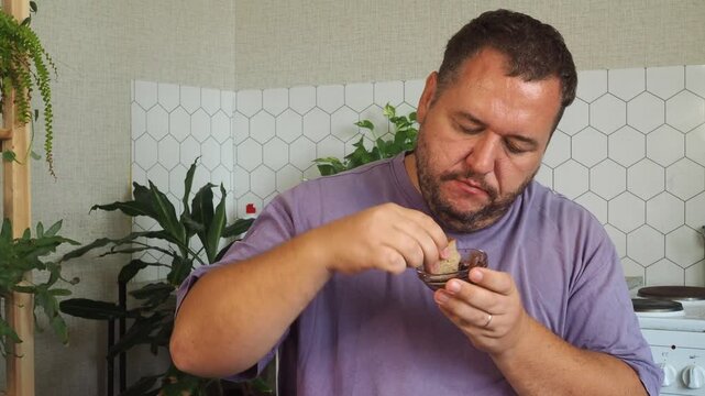 a grown man is having lunch in the kitchen