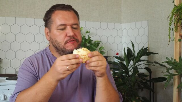 a grown man is having lunch in the kitchen