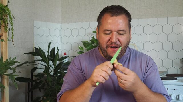 a grown man is having lunch in the kitchen