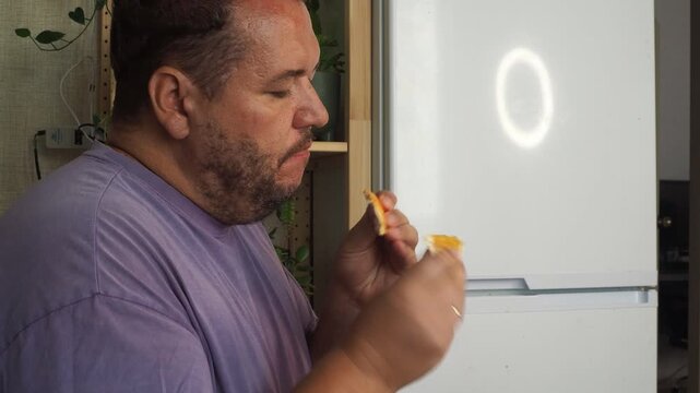 a grown man is having lunch in the kitchen