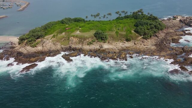 A top view of the sandy isthmus between the island and the mainland. The Blue Island, located at the southern tip of Sri Lanka, is becoming an increasingly popular tourist destination. A tropical dron