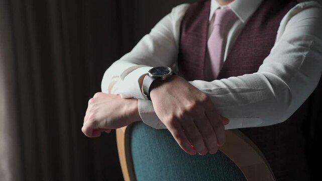 A man in a jacket sits by the window