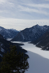 Frozen Plansee lake in Austrian Alps, winter mountain landscape in Tyrol