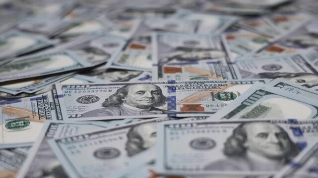Hundred-dollar bills arranged on a surface. Finance, money, business, wealth and economic concept.