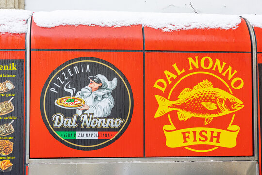 Dal Nonno Pizzeria Sign On Red Truck With Snowy Roof And Italian Fish Branding