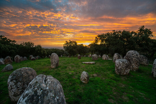 Sunrise at the Cromeleque dos Almendres near &Eacute;vora, Alentejo, Portugal. An ancient Neolithic stone circle, one of the largest megalithic monuments in Europe, bathed in soft morning light.