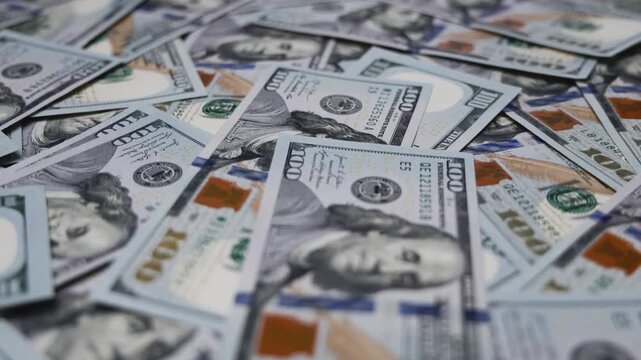 Hundred-dollar bills arranged on a flat surface. Finance, money, wealth, business capital and economic concept.