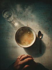 Warm soup and quiet moments at a small kitchen table during evening