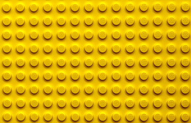Obraz premium Vibrant Yellow LEGO Brick Surface Texture Background